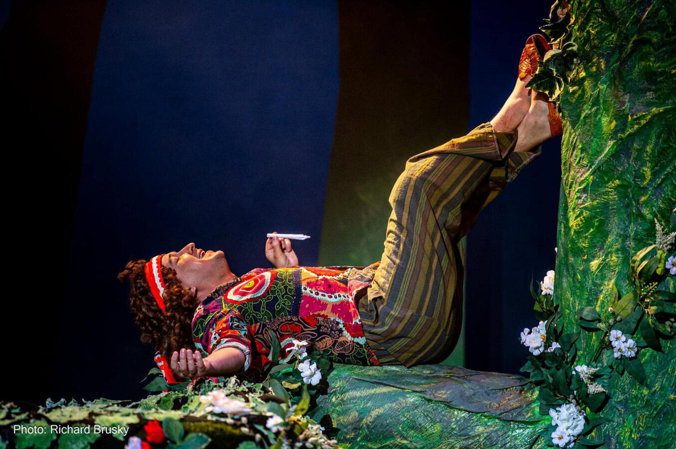 A Midsummer Night's Dream by William Shakespeare (2022) Puck, a hippie fairy, is smoking a joint laying on a giant tree.